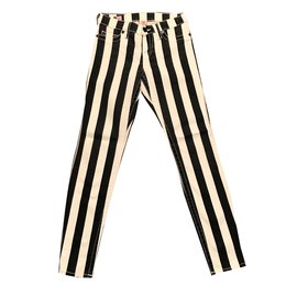 Vaqueros slim True Religion con rayas negras y blancas