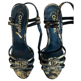 Mule con zeppa Chanel in pelle dorata
