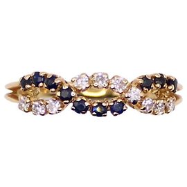 Autre Marque Anello in oro giallo con zaffiri intrecciati e diamanti 750%O
