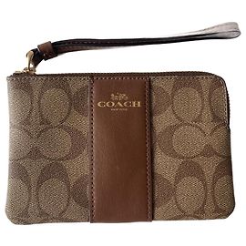 Pochette Coach in pelle color caramello