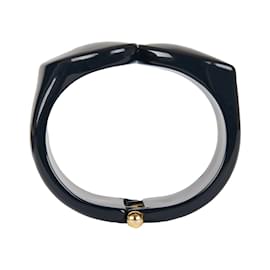 Autre Marque Bracciale scultoreo in resina nera con chiusura dorata