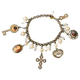 Stupendo raro bracciale vintage DOLCE & GABBANA acciaio dorato con cammeo croce vari charms
