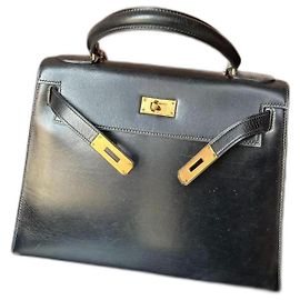 Hermès Kelly 28 cuero negro y dorado
