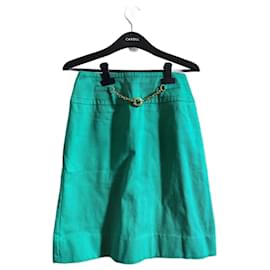 Falda de algodón verde Céline con forma de trapecio y cinturón dorado