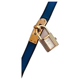 Montre Hermès Kelly plaqué or cadran blanc bracelet bleu