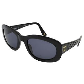 Occhiali da sole Chanel neri e dorati in plastica