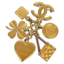 Spilla CC Chanel dorata con charm
