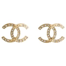 Orecchini Chanel in metallo dorato e strass