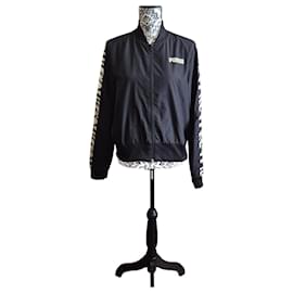Chaqueta impermeable Puma de media temporada en negro con banda de cebra beige, talla M 38