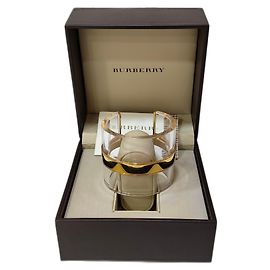 Pulsera tipo mancuerna Burberry transparente con detalles dorados