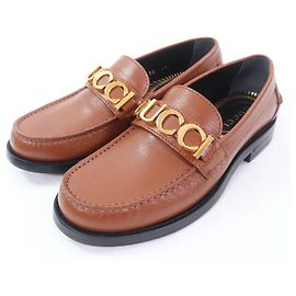 Mocassini in pelle con logo Gucci in metallo