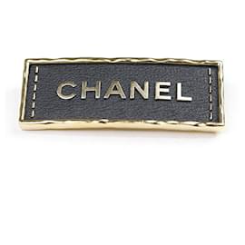 Spilla in pelle e metallo nero e oro Chanel