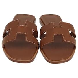 Sandali Oran in pelle box calf oro di Hermès