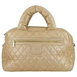 Borsa bowling Coco Cocoon in pelle di agnello metallizzata trapuntata dorata di Chanel