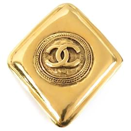 Spilla in metallo dorato Chanel con il marchio Coco