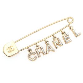 Spilla in metallo dorato con strass Chanel