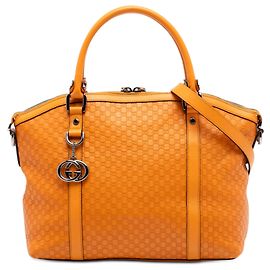 Borsa a mano a cupola Medium Microguccissima GG Charm arancione di Gucci