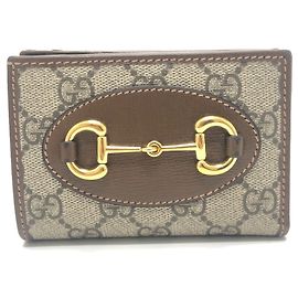 Billetera bi-fold Gucci GG Supreme marrón