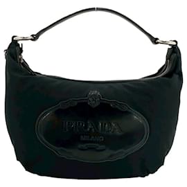 Mini borsa tote in nylon nero e pelle verniciata Prada