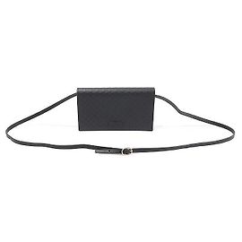 Clutch a tracolla in pelle micro Guccissima con logo GG nero