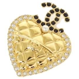 Spilla Chanel in nero, oro e bianco