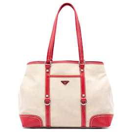 Tote in tela beige di Prada con bordi in pelle borchiata e tasca anteriore