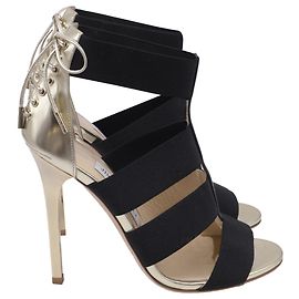 Sandalias de tacón Jimmy Choo con tira elástica en piel dorada
