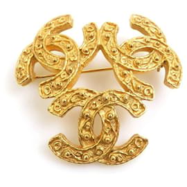 Spilla in metallo dorato Chanel