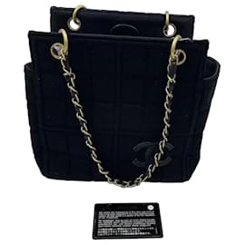 Bolso Chanel de tela negra acolchada con cadena dorada