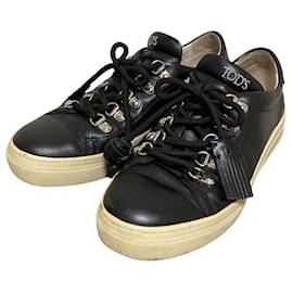 Sneakers con lacci e nappe in pelle Tod's