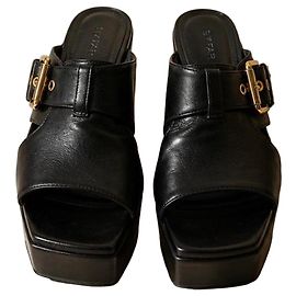 By Far Mules à plateforme en cuir