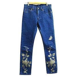Pantalones de denim stretch con bordado de flores y mariposas Gucci