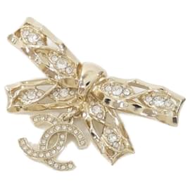 Broche Chanel transparente y dorada
