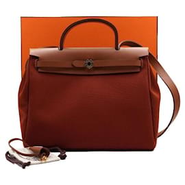 Tote e borsa a tracolla in pelle arancione con finiture metalliche - Hermès
