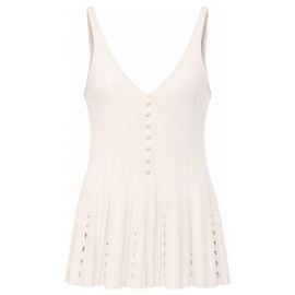 Top Chanel Primavera 2012 rosa pálido de punto acordeón con botones de perla y bajo peplum