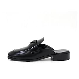 Prada Mules in pelle spazzolata nera con logo triangolare