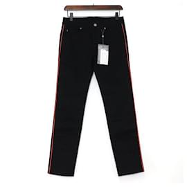 Alexander Mcqueen Vaqueros de denim negros para mujer con raya lateral naranja