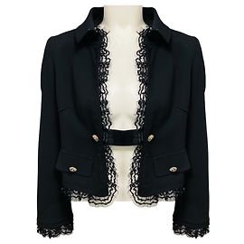 Giacca cropped Dolce & Gabbana in crepe di lana nera con paillettes, tulle mesh e bordo in pizzo con bottoni argentati