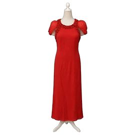 Paule Ka Langes rotes Kleid mit Perlen und Schleifen verziert