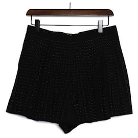 Saint Laurent Mini falda plisada con shorts y estampado de lunares