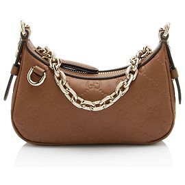 Mini borsa a tracolla in pelle con emblema GG in rilievo Gucci