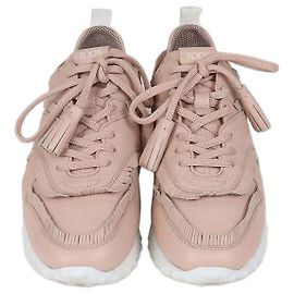 Sneakers basse Tod's in pelle traforata rosa con frange e nappe