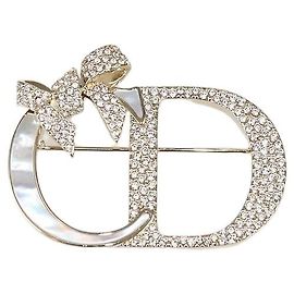 Spilla Christian Dior Shiny Bow in metallo finish oro e madreperla