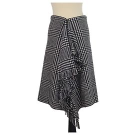 Falda longitud rodilla Balenciaga de lana con estampado de pata de gallo negro/blanco, volantes y flecos