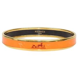 Hermès Pulsera rígida estrecha Caleche de esmalte naranja chapada en oro Hermes
