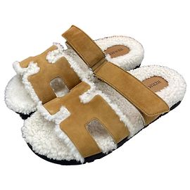 Hermès Sandali pantofole in shearling da donna Marrone