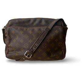 Louis Vuitton Nile A beautiful vintage Nile from Louis Vuitton. The bag has a lovely solid and adjustable strap. It has several compartments with zippers and pockets inside. The inside of the bag is in good condition with general signs of use. Overall, the bag is slightly out of shape, but that is part of its charm, if you ask us.