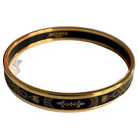 Pulsera rígida Hermès en metal dorado y esmalte negro