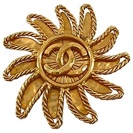 Spilla Chanel CC placcata oro con motivo sole