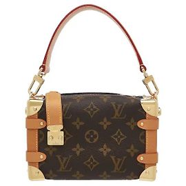The Side Trunk PM reinterprets Louis Vuitton's historic trunk-making craftsmanship in a modern sensibility, showcasing Nicolas Ghesquiere's innovative design. The iconic Monogram canvas harmonizes